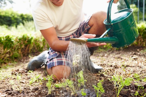 Artificial grass being installed in a Thorntonheath garden with prepared sub-base
